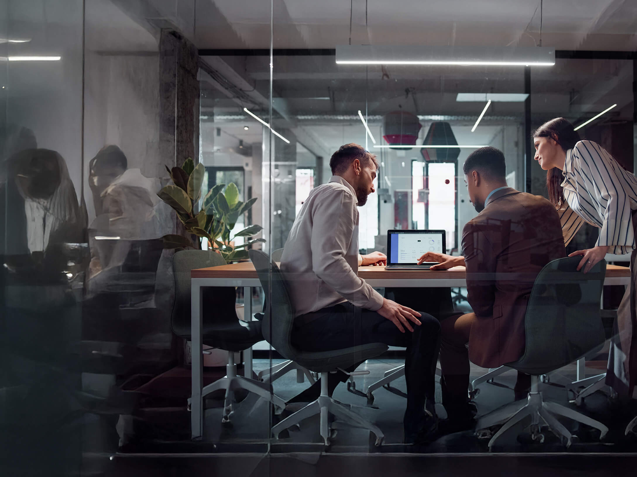 A group of colleagues looking at a workscreen in an office 