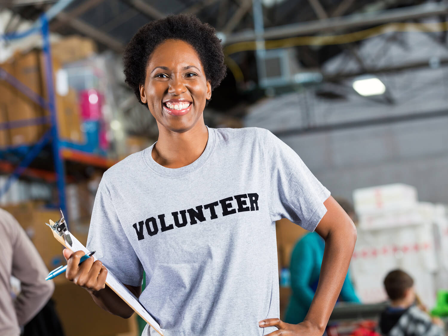 A female professional woking during a volunteering day at a warehouse