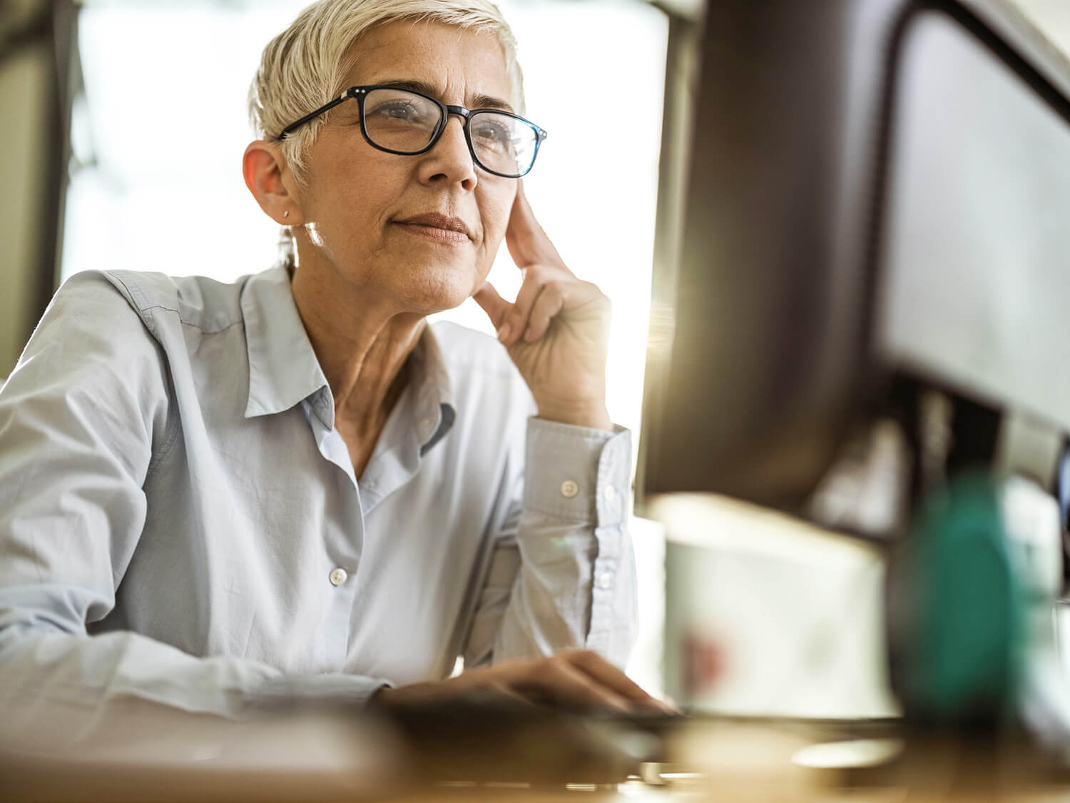 A business woman reading something on screen 