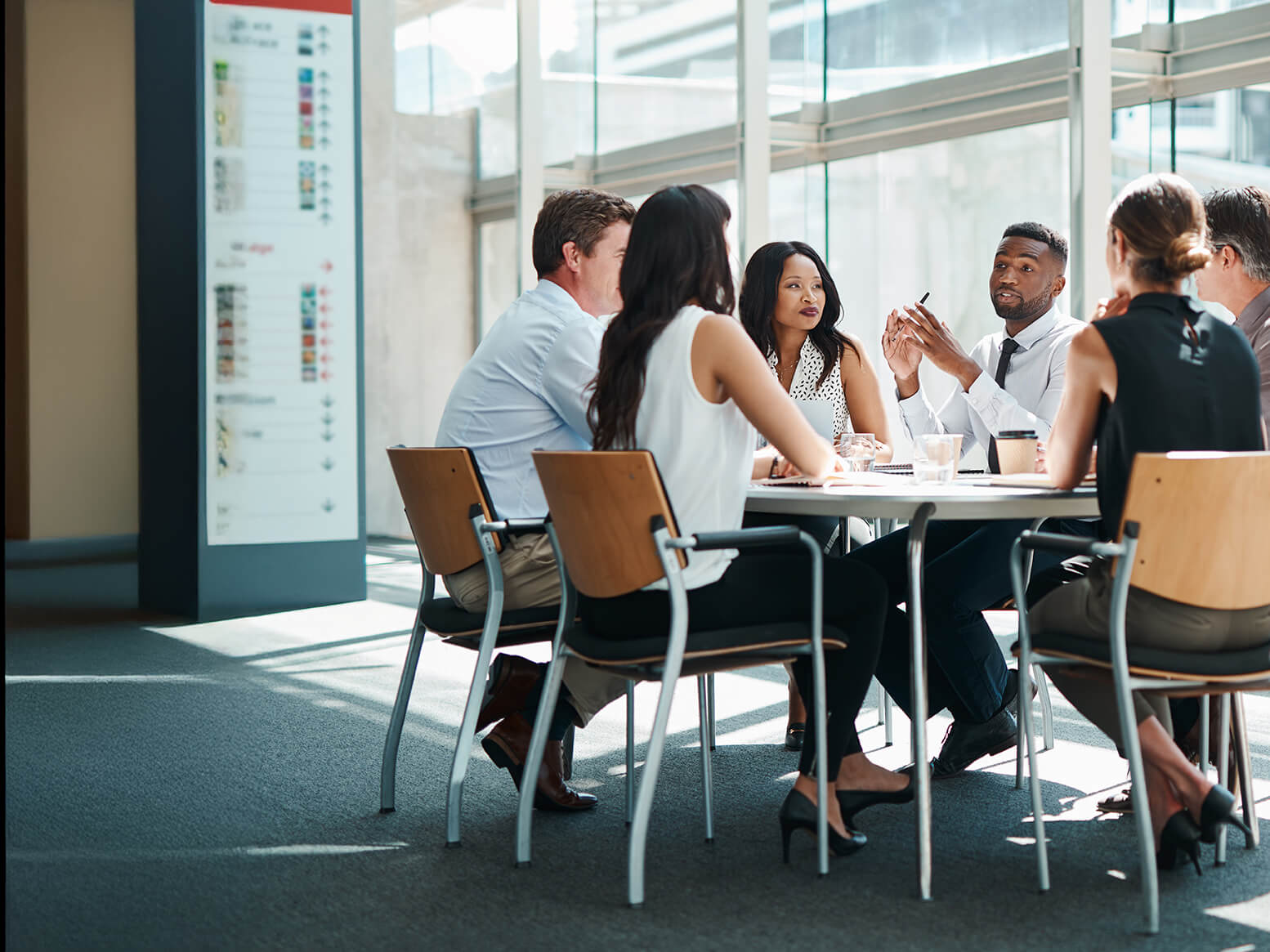 A mdiverse group of professions seated at a meeting