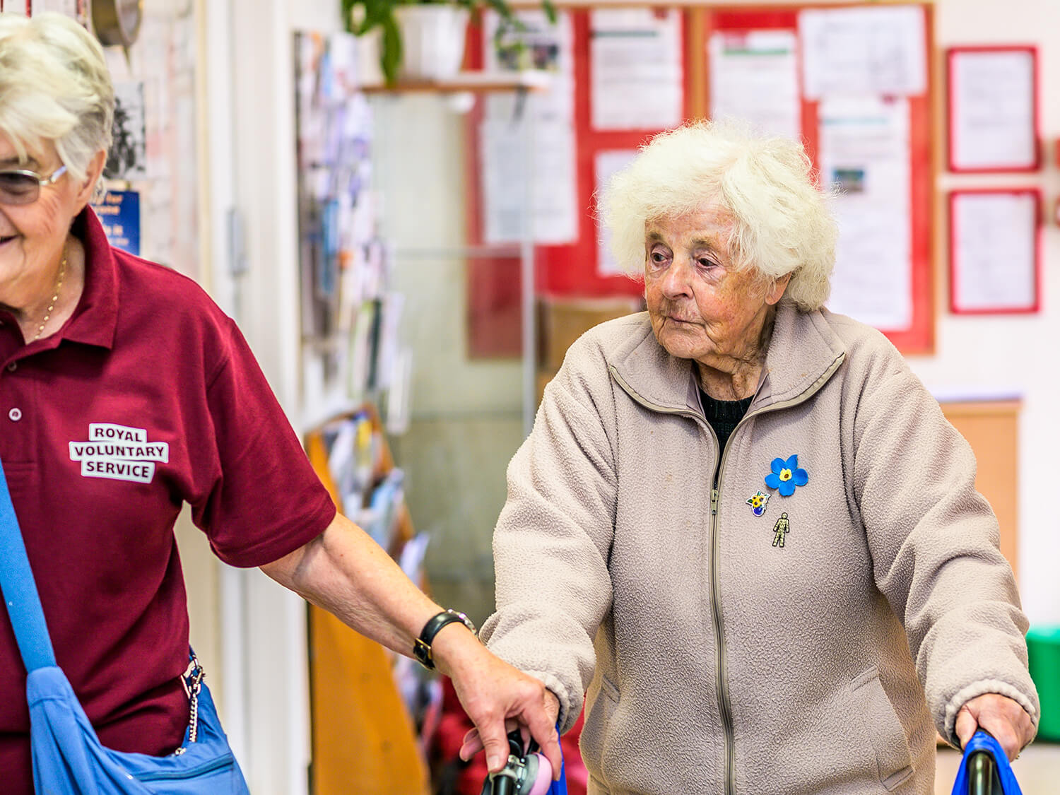 A Royal Voluntary Service volunteer supporting a visitor at a community centre 